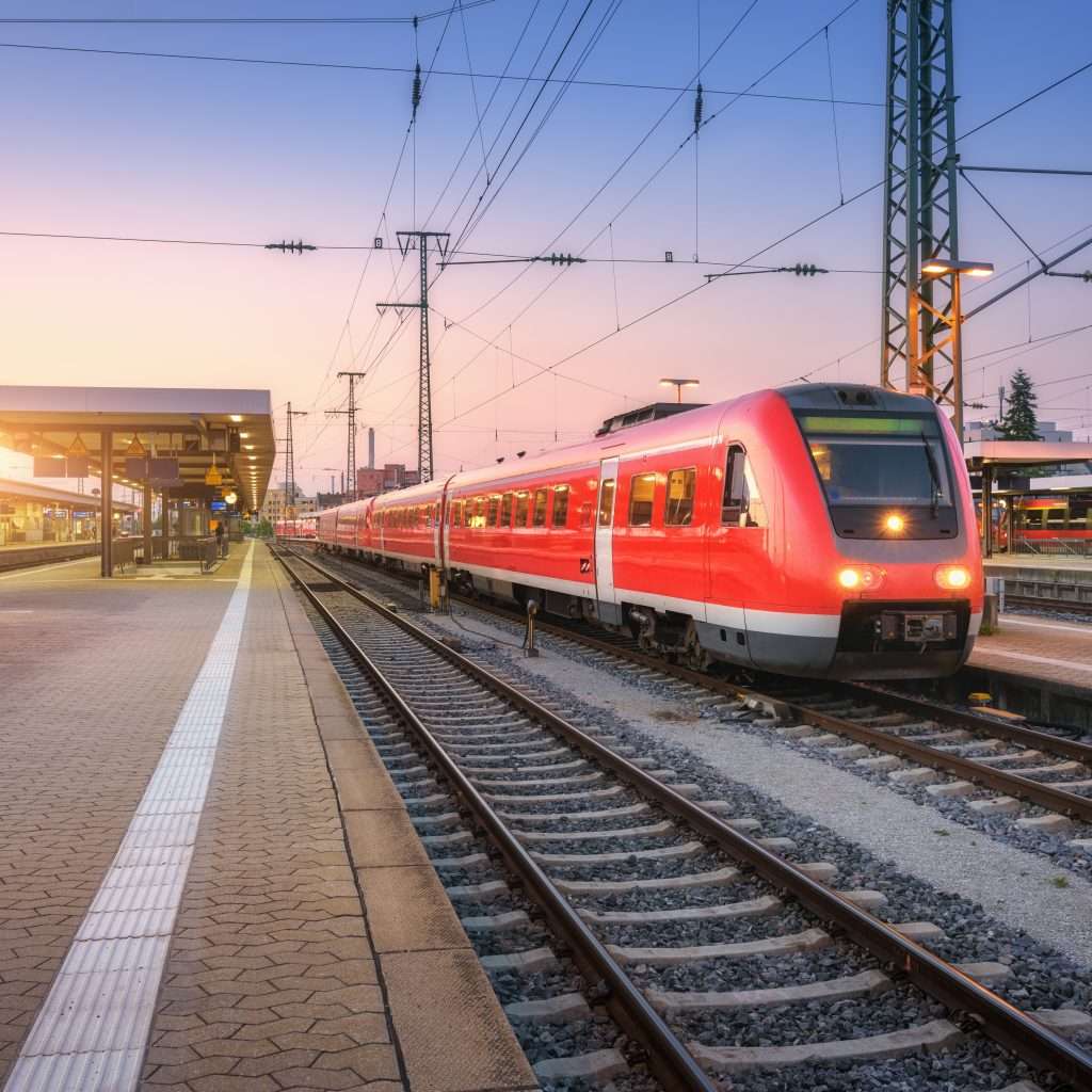 Passenger high speed train on the railway station at sunset