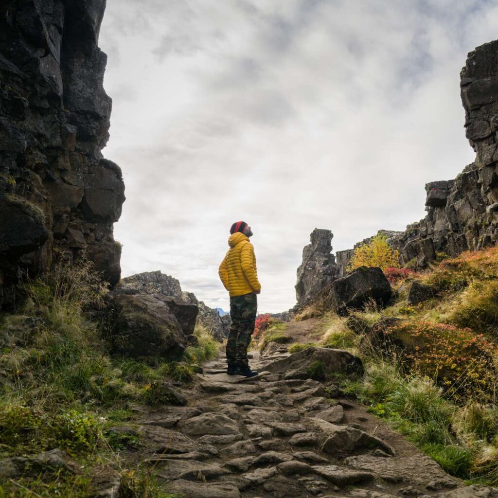 man walking between the tectonic plates in the Thingvellir national park
